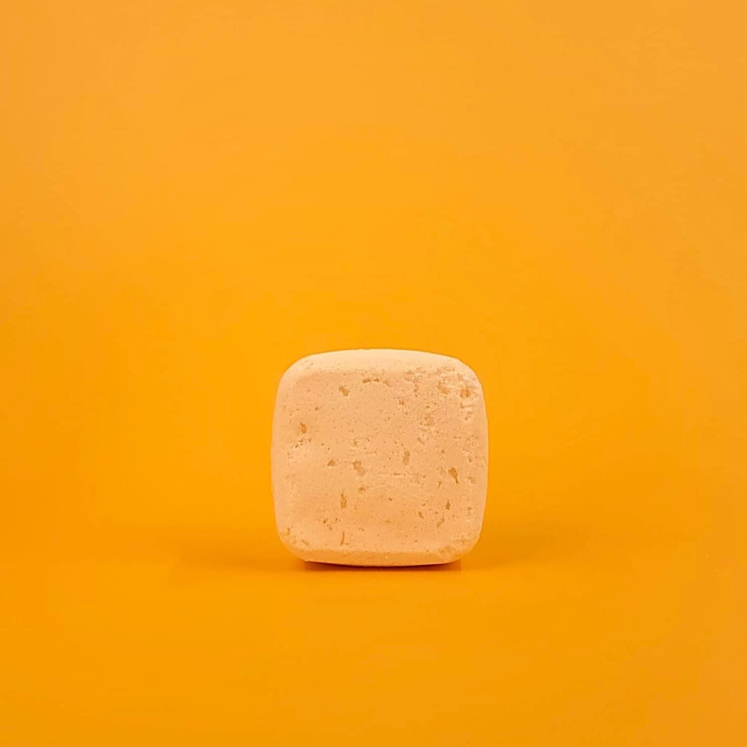 Square bar of soap on a gradient orange background